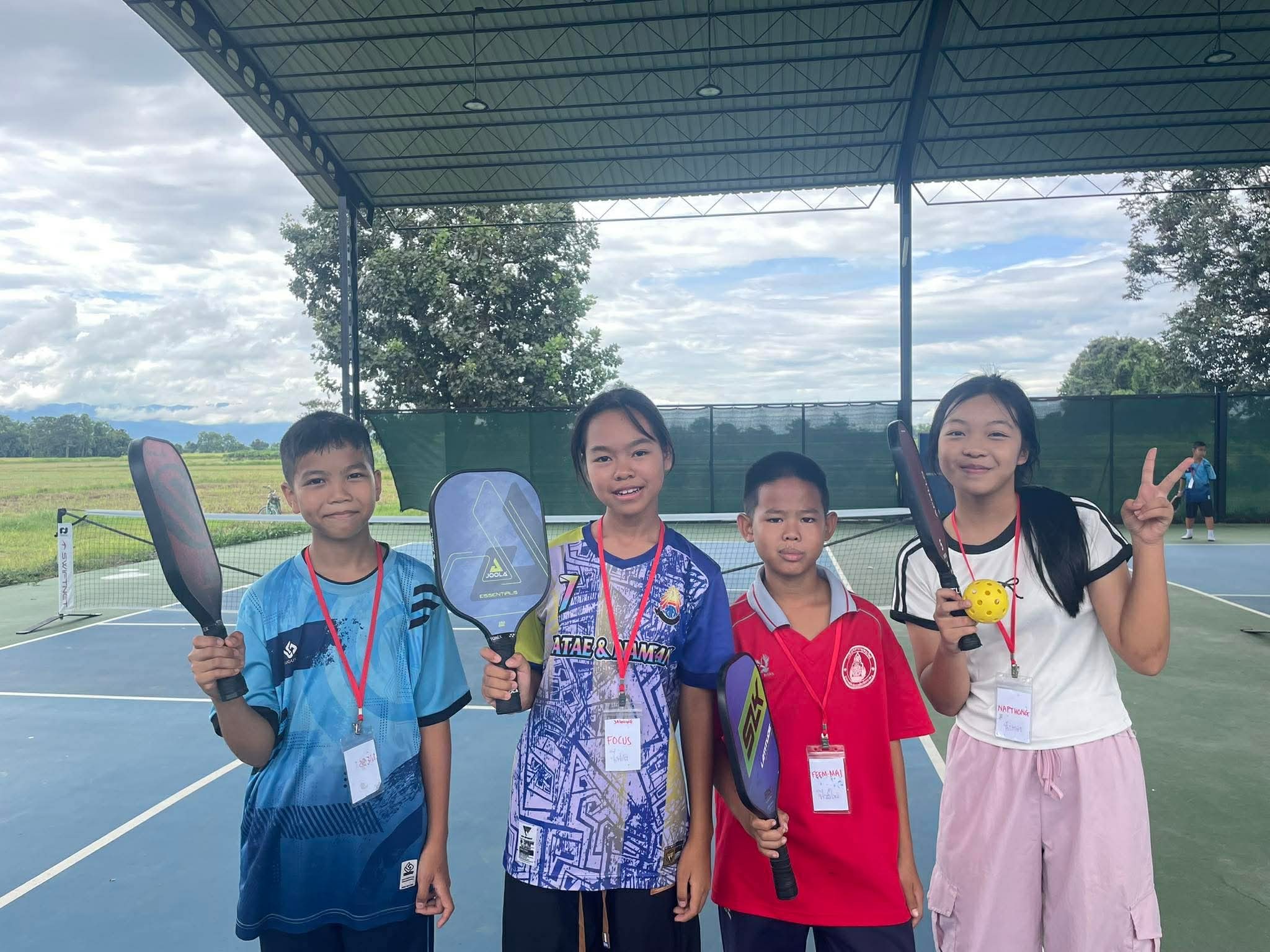 Daughters and local children on pickleball courts at Jasmine Farm