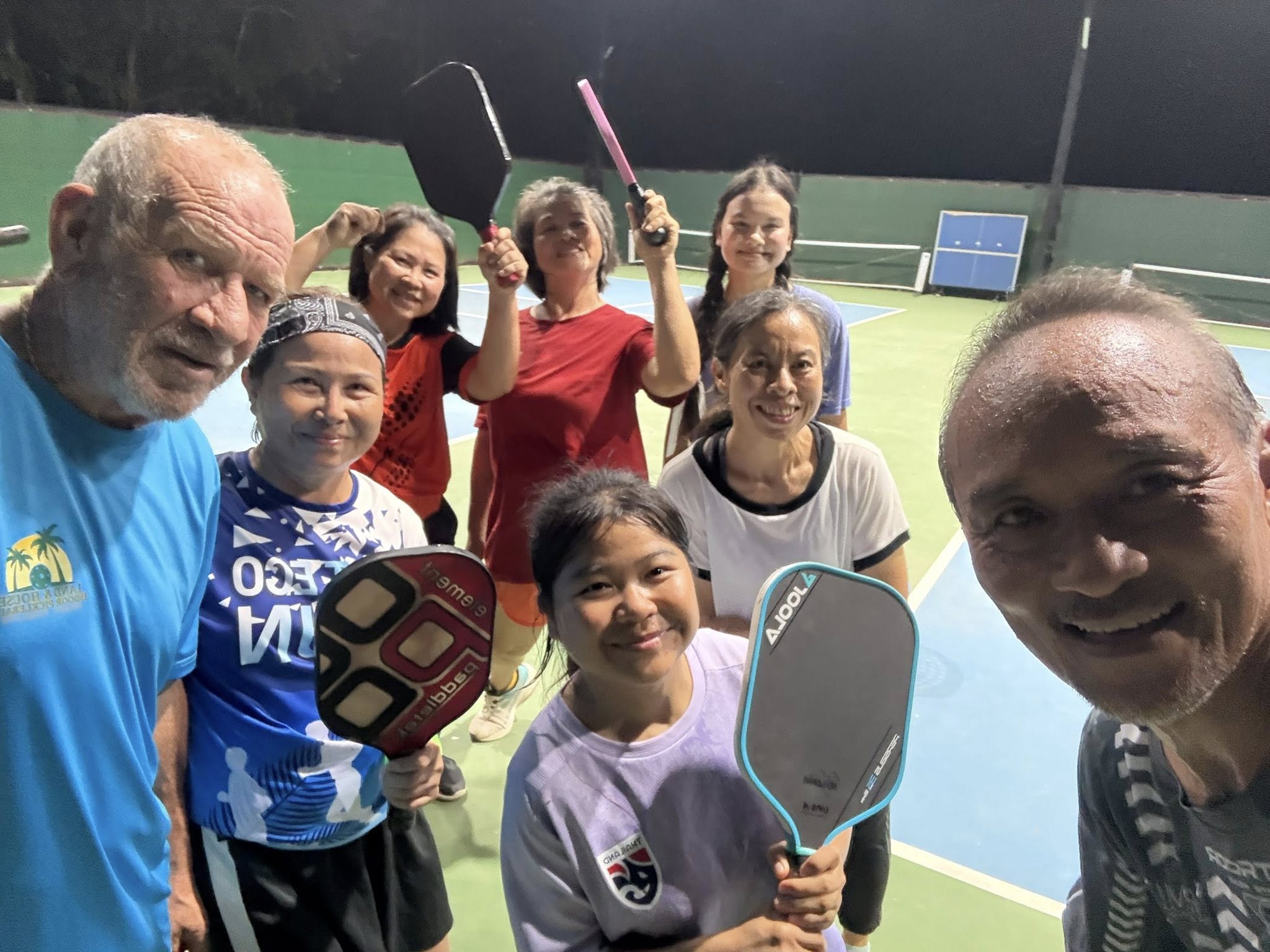Closeup of Phuket visitors and Daughters at end of pickleball match on courts