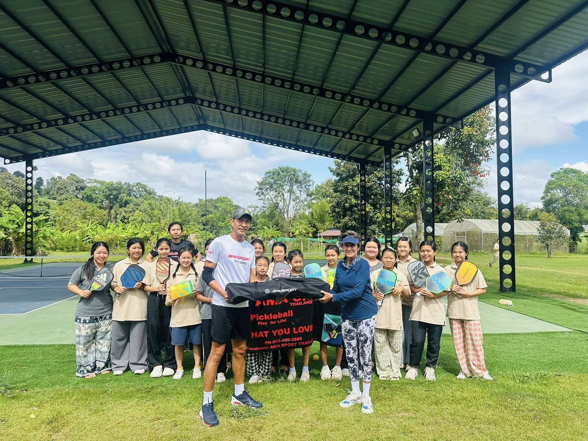 AMA Sports presents paddles, balls, nets and shoes to Jane McBride at Sunflower Farm