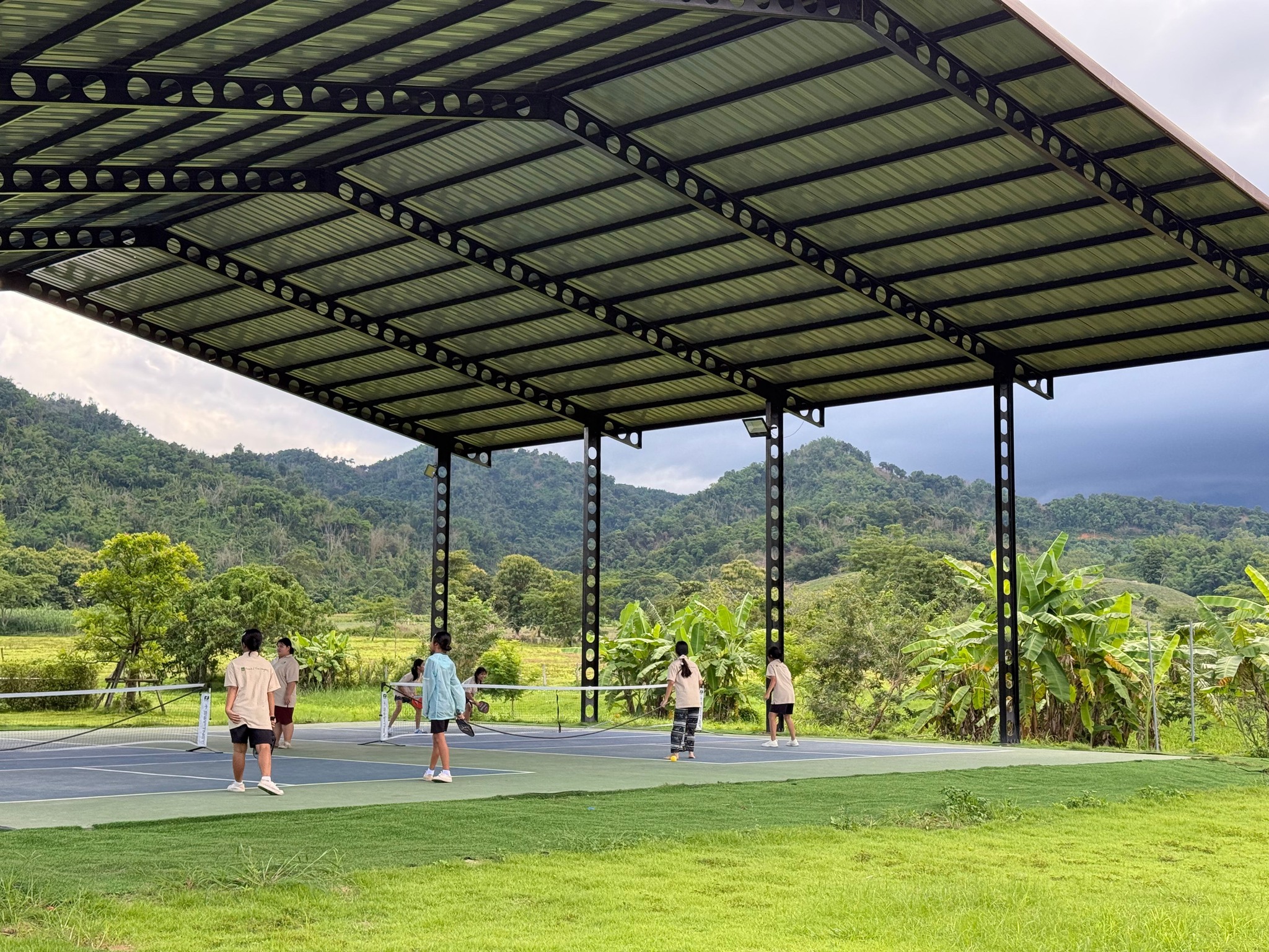 Long shot of girls playing pickleball at Sunflower Farm